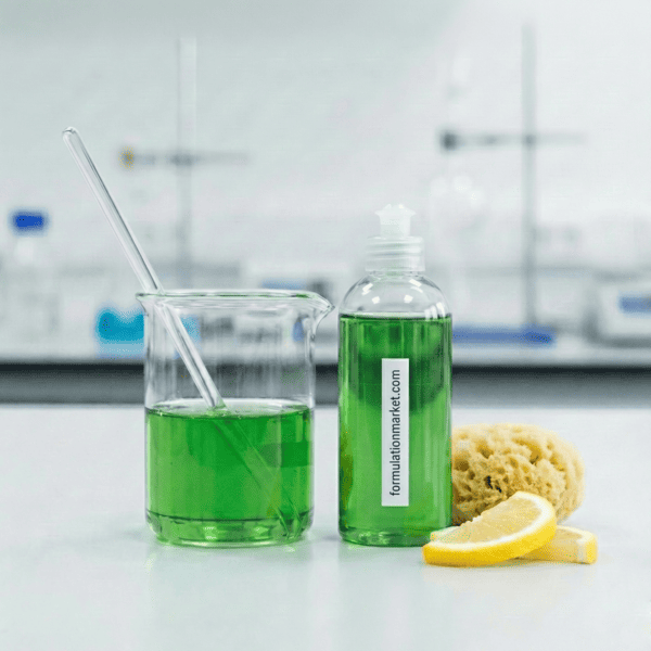 Ultra concentrated green dishwashing liquid gel drop on a spoon showing high viscosity and clarity.